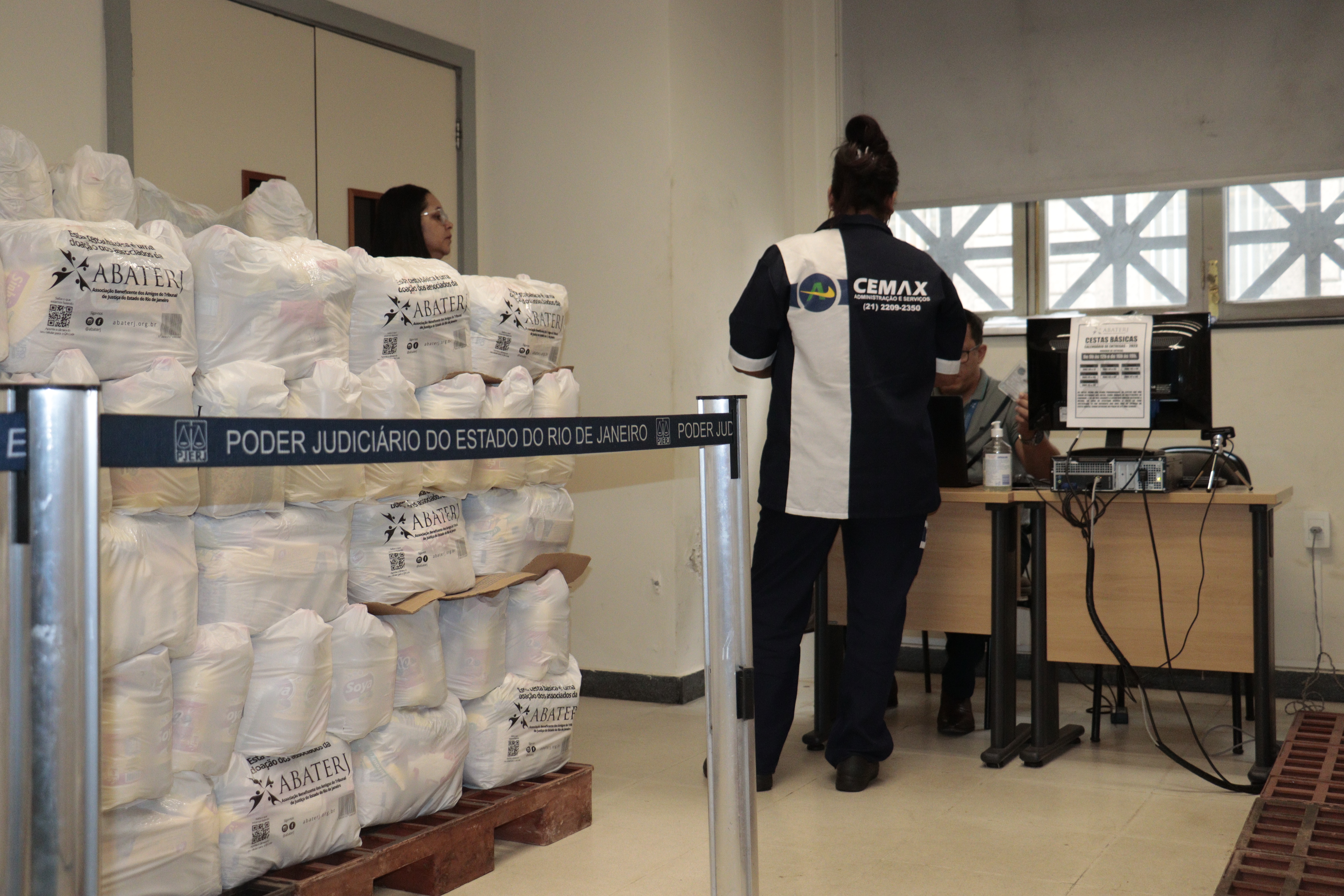 Mulher de costas solicitando a retirada da cesta básica.