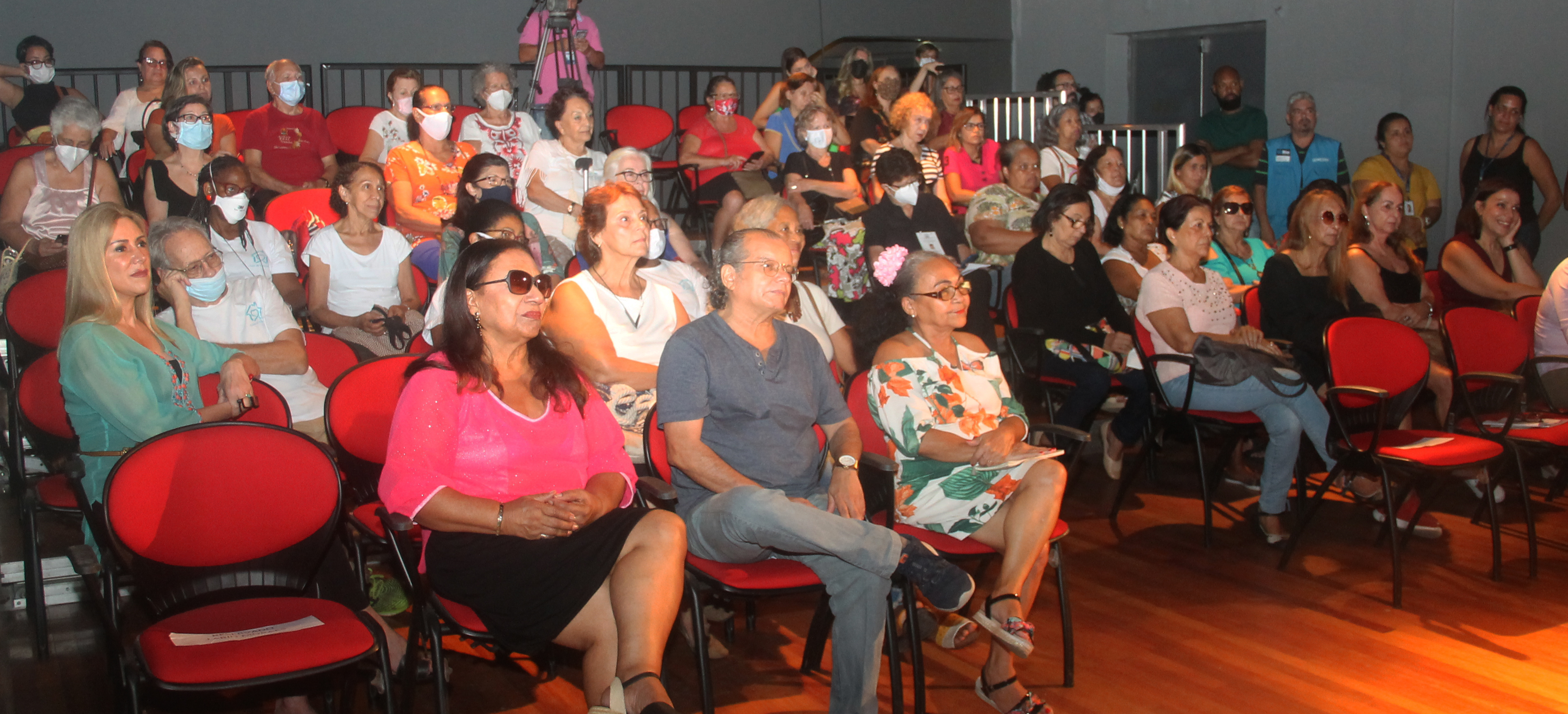 Imagem da plateia acompanhando sentada poesias sendo declamadas