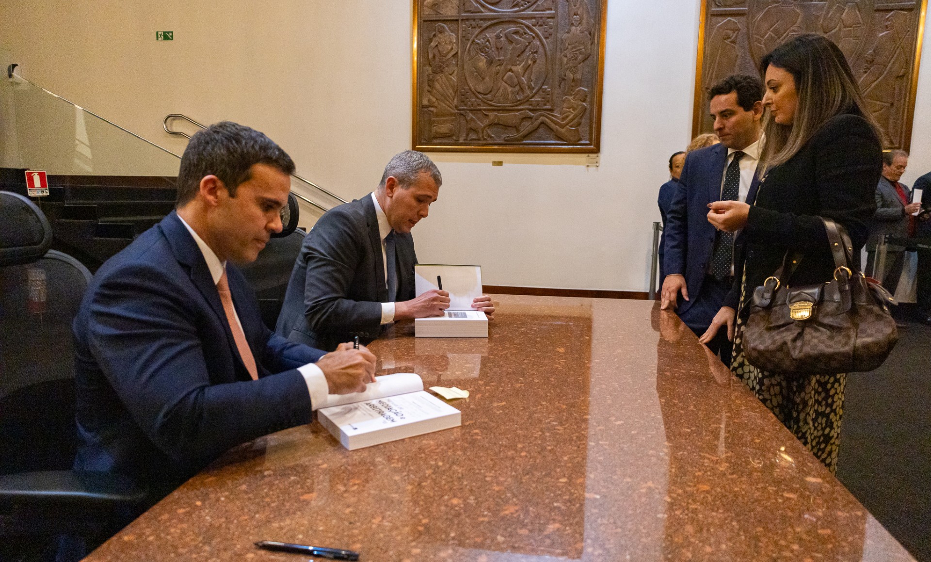 Os autores autografando os livros no Foyer do  Plenário Desembargador Estenio Cantarino Cardozo
