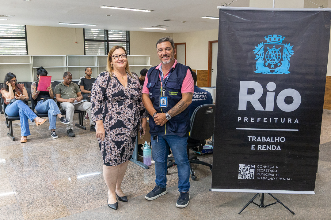 Imagem da Juíza Cláudia Márcia Vidal e diretor do Trabalha Rio Luis Faro ao lado do banner da ação